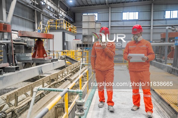 Workers carry out routine inspections on the facilities and equipment of the Ferriichong phosphate mine in Hualuo Village, Sanjia Street, Zh...