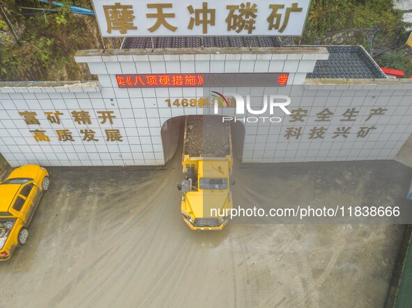 Workers load mined phosphate rocks into trucks at the plant of the Ferriichong phosphate mine in Hualuo village, Sanjia street, Zhijin Count...