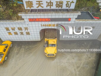 Workers load mined phosphate rocks into trucks at the plant of the Ferriichong phosphate mine in Hualuo village, Sanjia street, Zhijin Count...