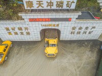 Workers load mined phosphate rocks into trucks at the plant of the Ferriichong phosphate mine in Hualuo village, Sanjia street, Zhijin Count...