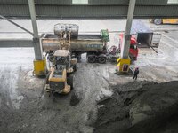 Workers load phosphate ore products at the plant of the Ferriichong phosphorus mine in Hualuo village, Sanjia street, Zhijin County, in Biji...