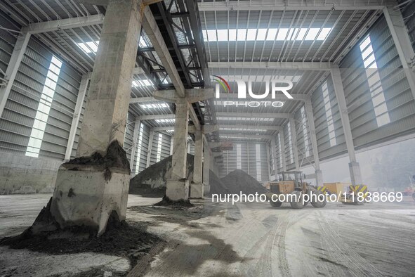 Workers load phosphate ore products at the plant of the Ferriichong phosphorus mine in Hualuo village, Sanjia street, Zhijin County, in Biji...