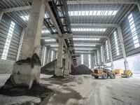 Workers load phosphate ore products at the plant of the Ferriichong phosphorus mine in Hualuo village, Sanjia street, Zhijin County, in Biji...