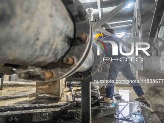 Workers carry out routine inspections on the facilities and equipment of the Ferriichong phosphate mine in Hualuo Village, Sanjia Street, Zh...