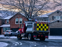 A snow plow applies ice-melting road salt to a road following the first snowfall of the season in Toronto, Ontario, Canada, on December 5, 2...