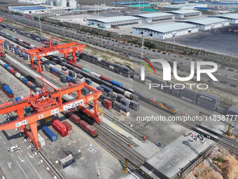 The X9578 Western Land-Sea New Channel rail and sea combined transport train departs from Qinzhou Railway Container Center station in Qinzho...