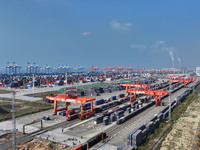 The X9578 Western Land-Sea New Channel rail and sea combined transport train departs from Qinzhou Railway Container Center station in Qinzho...