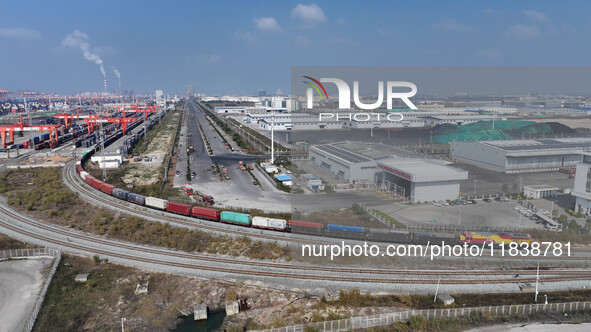 The X9578 Western Land-Sea New Channel rail and sea combined transport train departs from Qinzhou Railway Container Center station in Qinzho...