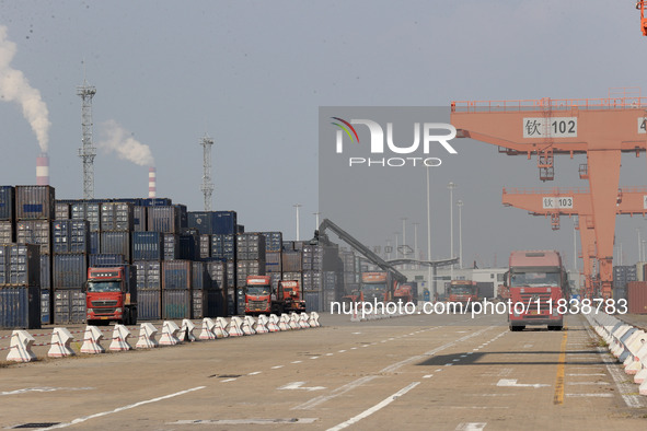 Freight cars transport containers in preparation for a rail-sea intermodal train in Qinzhou City, South China, on December 5, 2024. 