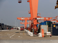 Freight cars transport containers in preparation for a rail-sea intermodal train in Qinzhou City, South China, on December 5, 2024. (