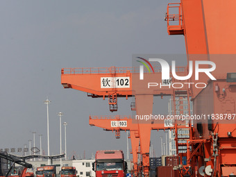 Freight cars transport containers in preparation for a rail-sea intermodal train in Qinzhou City, South China, on December 5, 2024. (