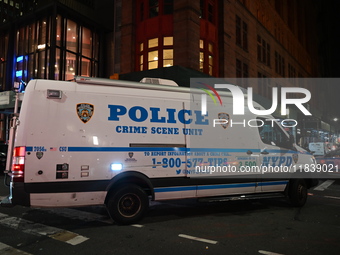 The NYPD Crime Scene Unit investigates the scene where one teenage boy is killed and one man is wounded in a stabbing in the Financial Distr...