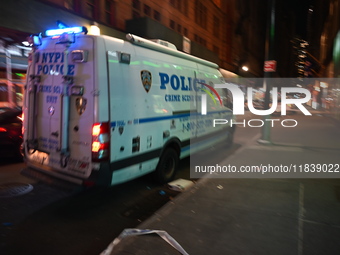 The NYPD Crime Scene Unit investigates the scene where one teenage boy is killed and one man is wounded in a stabbing in the Financial Distr...