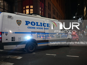 The NYPD Crime Scene Unit investigates the scene where one teenage boy is killed and one man is wounded in a stabbing in the Financial Distr...