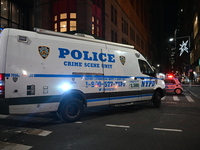 The NYPD Crime Scene Unit investigates the scene where one teenage boy is killed and one man is wounded in a stabbing in the Financial Distr...