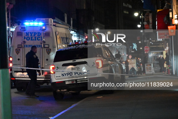 The NYPD Crime Scene Unit investigates the scene where one teenage boy is killed and one man is wounded in a stabbing in the Financial Distr...