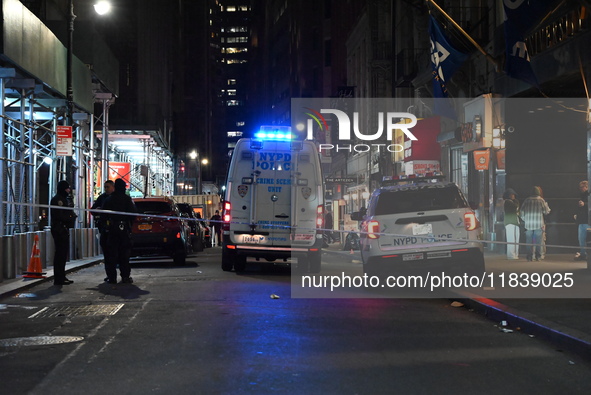 The NYPD Crime Scene Unit investigates the scene where one teenage boy is killed and one man is wounded in a stabbing in the Financial Distr...