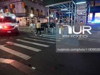 The NYPD Crime Scene Unit investigates the scene where one teenage boy is killed and one man is wounded in a stabbing in the Financial Distr...