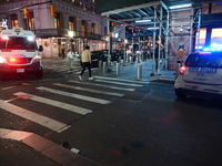 The NYPD Crime Scene Unit investigates the scene where one teenage boy is killed and one man is wounded in a stabbing in the Financial Distr...