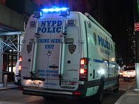 The NYPD Crime Scene Unit investigates the scene where one teenage boy is killed and one man is wounded in a stabbing in the Financial Distr...