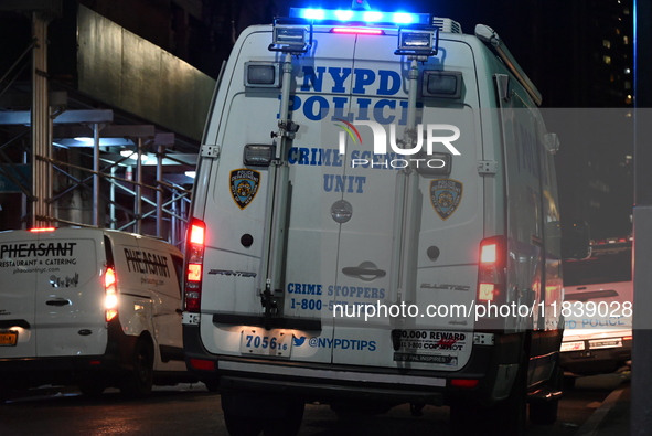 The NYPD Crime Scene Unit investigates the scene where one teenage boy is killed and one man is wounded in a stabbing in the Financial Distr...