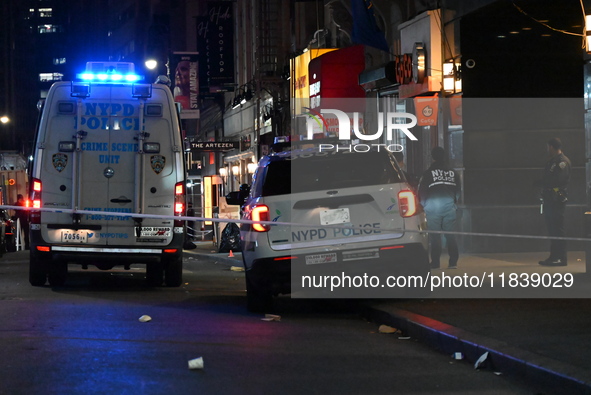 The NYPD Crime Scene Unit investigates the scene where one teenage boy is killed and one man is wounded in a stabbing in the Financial Distr...