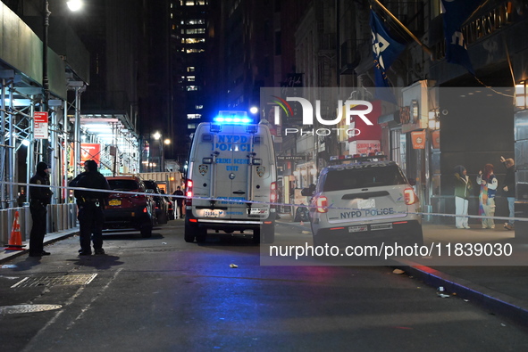 The NYPD Crime Scene Unit investigates the scene where one teenage boy is killed and one man is wounded in a stabbing in the Financial Distr...