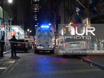 The NYPD Crime Scene Unit investigates the scene where one teenage boy is killed and one man is wounded in a stabbing in the Financial Distr...