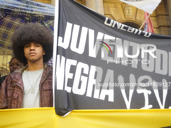 Demonstrators shout slogans as they participate in a protest against Sao Paulo's governor, Tarcisio de Freitas, and the violence of the poli...