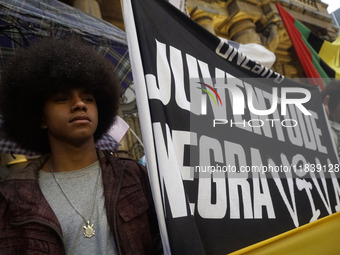 Demonstrators shout slogans as they participate in a protest against Sao Paulo's governor, Tarcisio de Freitas, and the violence of the poli...