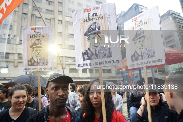 Demonstrators shout slogans as they participate in a protest against Sao Paulo's governor, Tarcisio de Freitas, and the violence of the poli...