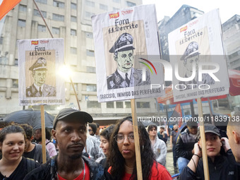 Demonstrators shout slogans as they participate in a protest against Sao Paulo's governor, Tarcisio de Freitas, and the violence of the poli...