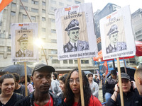 Demonstrators shout slogans as they participate in a protest against Sao Paulo's governor, Tarcisio de Freitas, and the violence of the poli...