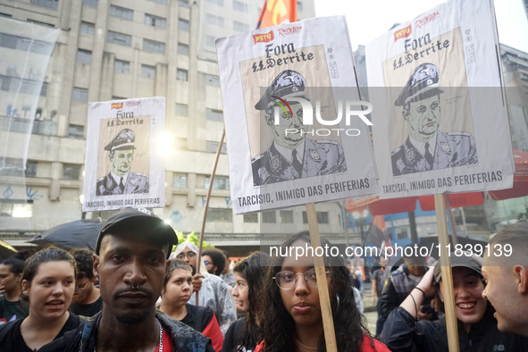 Demonstrators shout slogans as they participate in a protest against Sao Paulo's governor, Tarcisio de Freitas, and the violence of the poli...