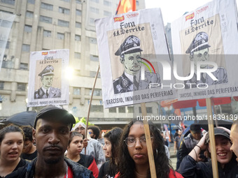 Demonstrators shout slogans as they participate in a protest against Sao Paulo's governor, Tarcisio de Freitas, and the violence of the poli...