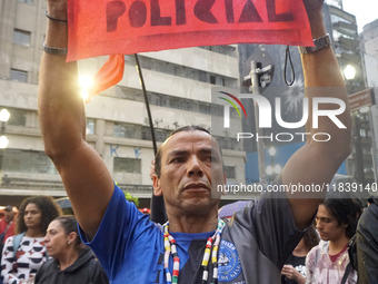 Demonstrators shout slogans as they participate in a protest against Sao Paulo's governor, Tarcisio de Freitas, and the violence of the poli...