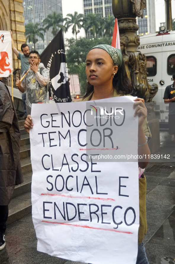 Demonstrators shout slogans as they participate in a protest against Sao Paulo's governor, Tarcisio de Freitas, and the violence of the poli...