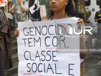 Demonstrators shout slogans as they participate in a protest against Sao Paulo's governor, Tarcisio de Freitas, and the violence of the poli...