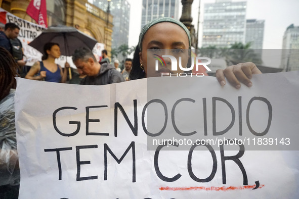 Demonstrators shout slogans as they participate in a protest against Sao Paulo's governor, Tarcisio de Freitas, and the violence of the poli...