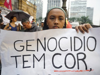 Demonstrators shout slogans as they participate in a protest against Sao Paulo's governor, Tarcisio de Freitas, and the violence of the poli...