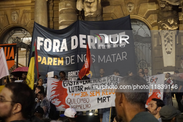 Demonstrators shout slogans as they participate in a protest against Sao Paulo's governor, Tarcisio de Freitas, and the violence of the poli...