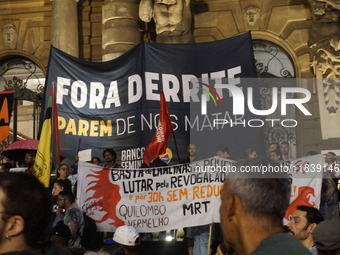 Demonstrators shout slogans as they participate in a protest against Sao Paulo's governor, Tarcisio de Freitas, and the violence of the poli...