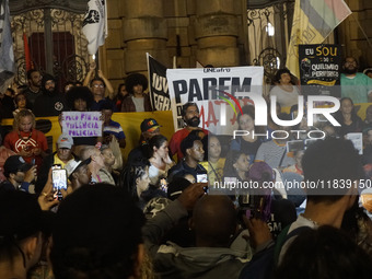 Demonstrators shout slogans as they participate in a protest against Sao Paulo's governor, Tarcisio de Freitas, and the violence of the poli...