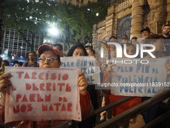 Demonstrators shout slogans as they participate in a protest against Sao Paulo's governor, Tarcisio de Freitas, and the violence of the poli...