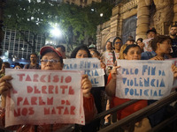 Demonstrators shout slogans as they participate in a protest against Sao Paulo's governor, Tarcisio de Freitas, and the violence of the poli...