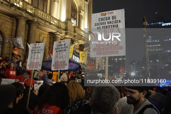 Demonstrators shout slogans as they participate in a protest against Sao Paulo's governor, Tarcisio de Freitas, and the violence of the poli...