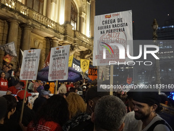 Demonstrators shout slogans as they participate in a protest against Sao Paulo's governor, Tarcisio de Freitas, and the violence of the poli...