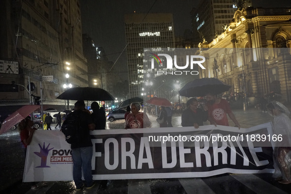 Demonstrators shout slogans as they participate in a protest against Sao Paulo's governor, Tarcisio de Freitas, and the violence of the poli...