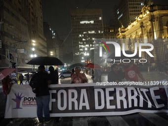 Demonstrators shout slogans as they participate in a protest against Sao Paulo's governor, Tarcisio de Freitas, and the violence of the poli...