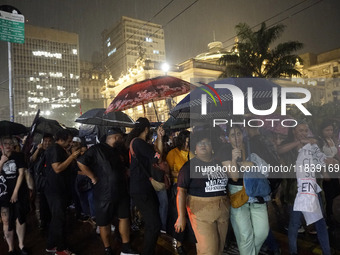 Demonstrators shout slogans as they participate in a protest against Sao Paulo's governor, Tarcisio de Freitas, and the violence of the poli...